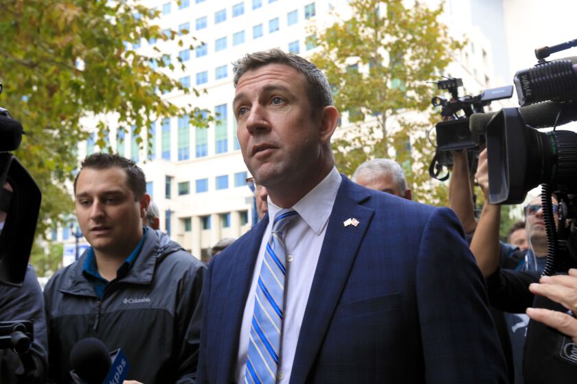 Congressman Duncan Hunter walks down the path on his way to Federal Court with his attorney, Paul Pfingst where he is expected to plead guilty.
