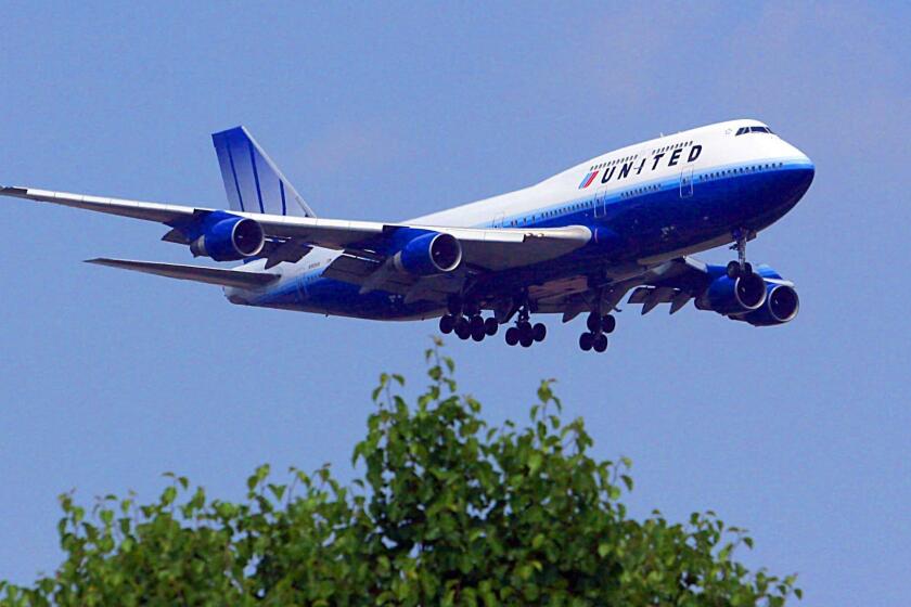 (FILES) This 02 June, 2007 photo shows a United Airlines 747 on approach for landing at Dulles International Airport in Dulles, Virginia. United Airlines, the second-largest US carrier, said it will lay off 950 pilots amid plans to reduce domestic flights in the face of skyrocketing fuel prices. UAL Corp, United's parent company, made the announcement late June 23, 2008, weeks after saying it was cutting its fleet operations and up to 1,100 additional jobs to offset soaring fuel bills and a weakening US economy. The layoffs of 950 pilots will affect about 15 percent of the pilots employed by United. AFP PHOTO/Karen BLEIER (Photo credit should read KAREN BLEIER/AFP/Getty Images) ORG XMIT: