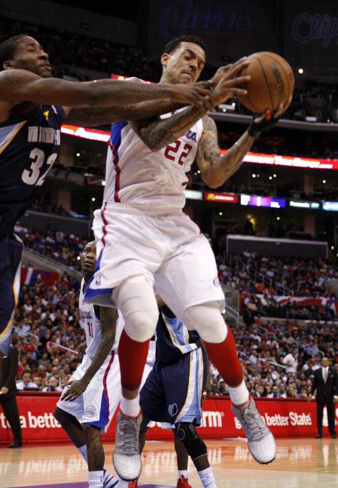 Clippers forward Matt Barnes tries to pull a rebound away from Grizzlies forward Ed Davis in the second half Wednesday night at Staples Center.