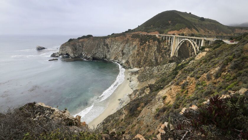 A scenic view shows the Bixby Bridge, an iconic California coastline gem.