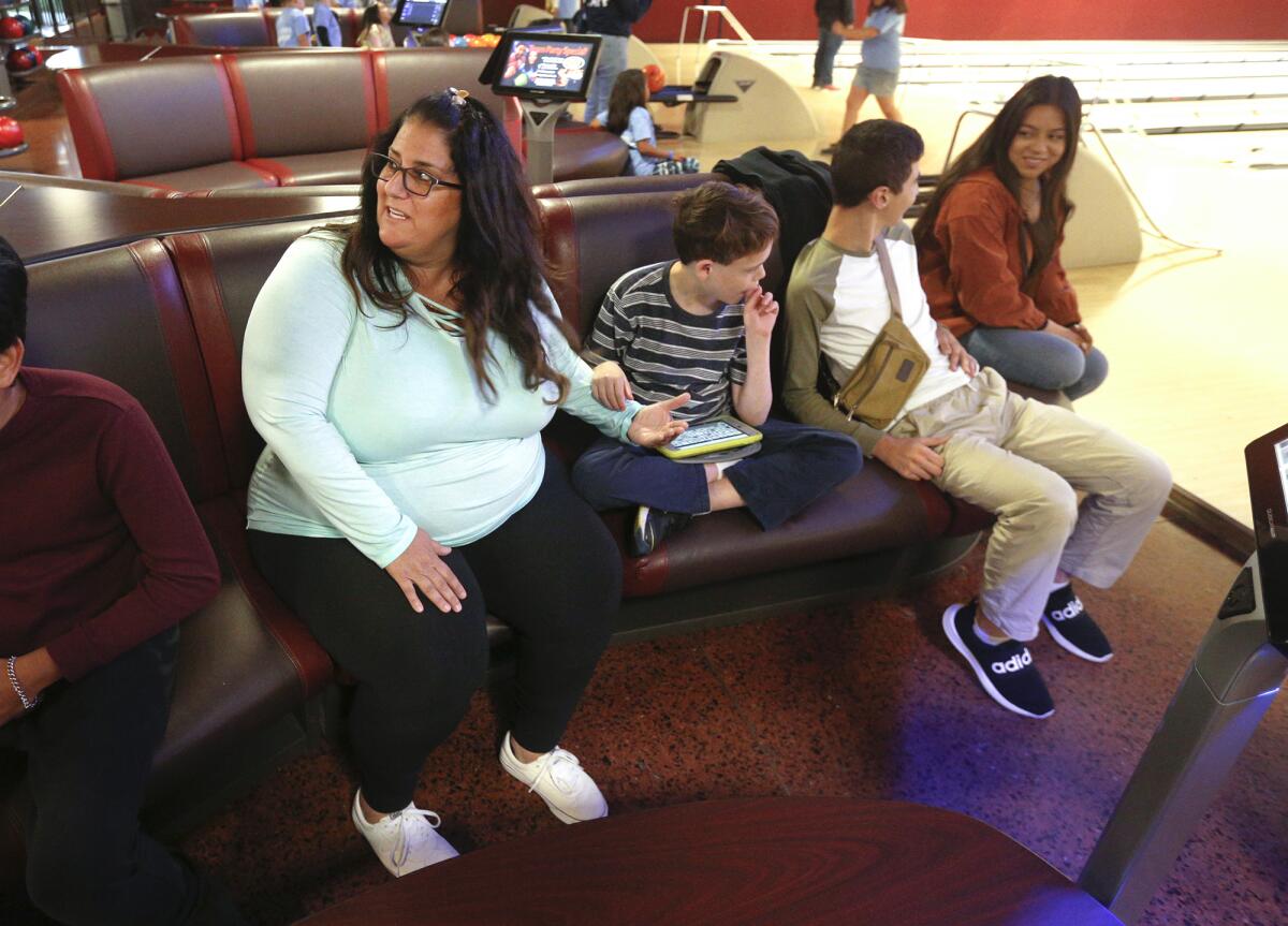 Newport Beach resident Nicole Fusaro  sits with some of her students last week.