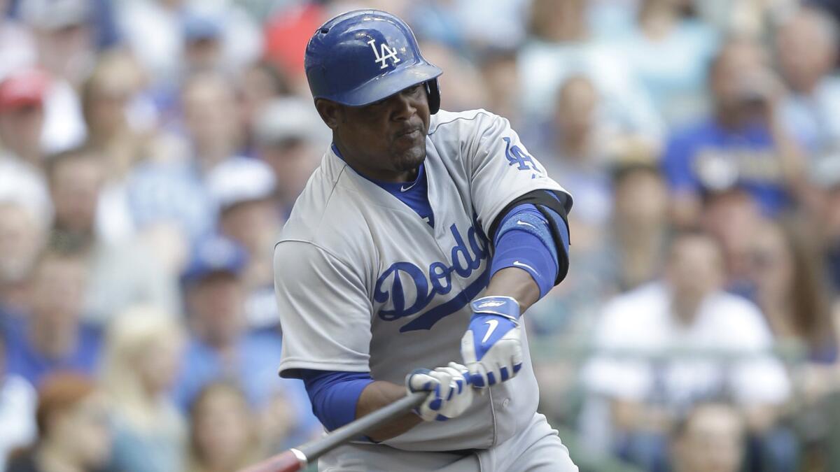 Dodgers third baseman Juan Uribe hits a run-scoring single against the Milwaukee Brewers on May 7, 2015.