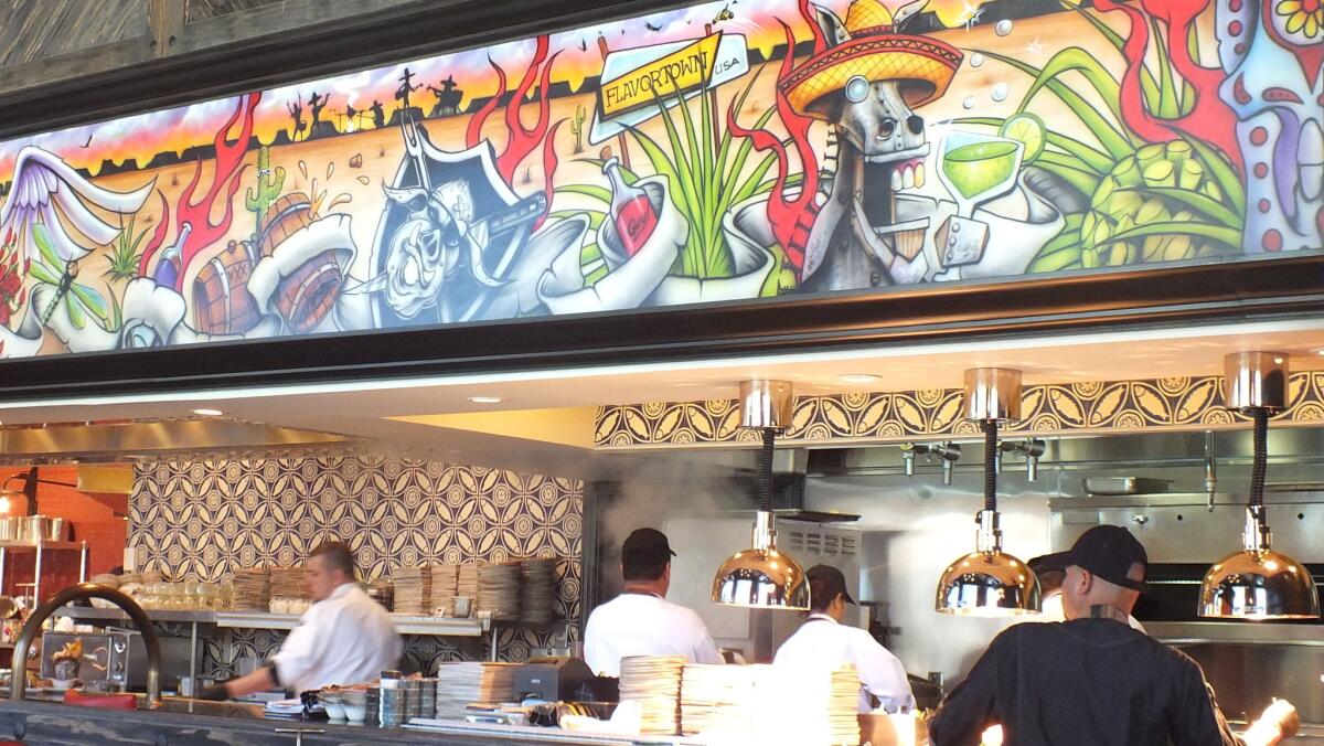 A mural above the kitchen prominently features the namesake drunken donkey at El Burro Borracho, Guy Fieri's newest eatery inside the Rio in Las Vegas.