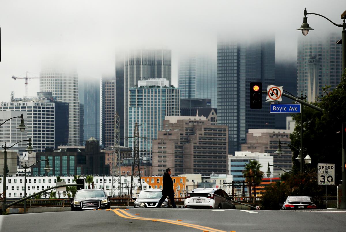 Rain clouds shroud the skyline of downtown Los Angeles on a rainy day.