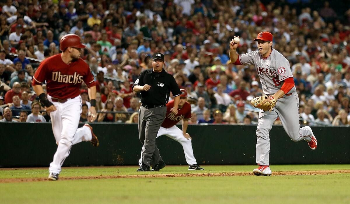 Angels infielder David Freese chases Diamondbacks' Chris Owings in a run down during the sixth inning on Wednesday.