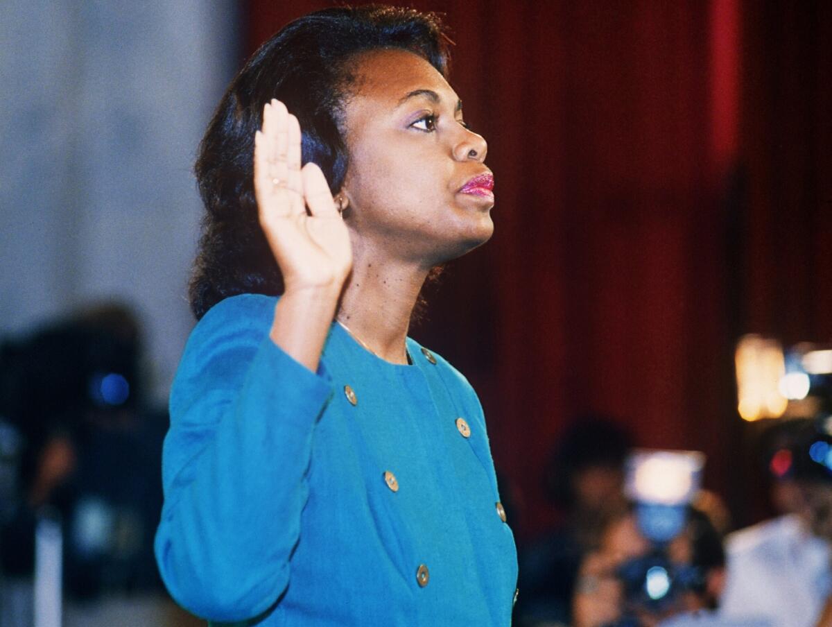 Law professor Anita Hill is sworn in before her testimony in front of the Senate Judiciary Committee in October 1991, where she would level sexual harassment charges against then-Supreme Court nominee Clarence Thomas.
