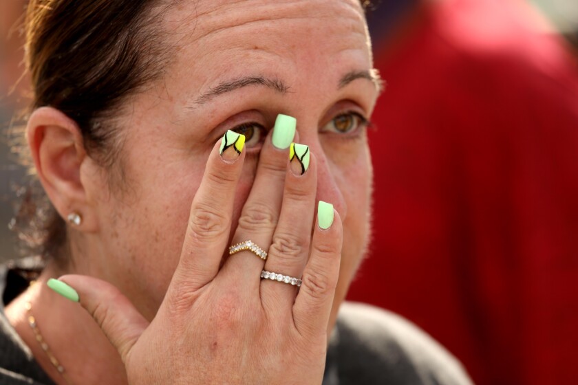 Yana Shmuliver wipes away a tear