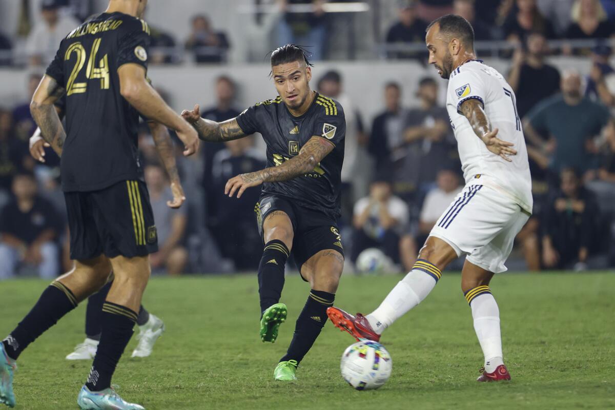 Los Angeles FC forward Cristian Arango (9) passes the ball against LA Galaxy midfielder Victor Vazquez (7).