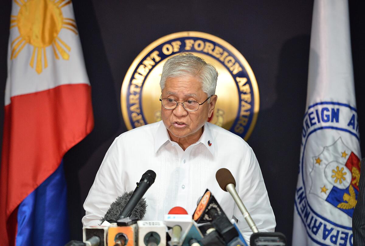 Philippines Foreign Affairs Secretary Albert del Rosario reads a statement during a press conference in Manila on Tuesday.
