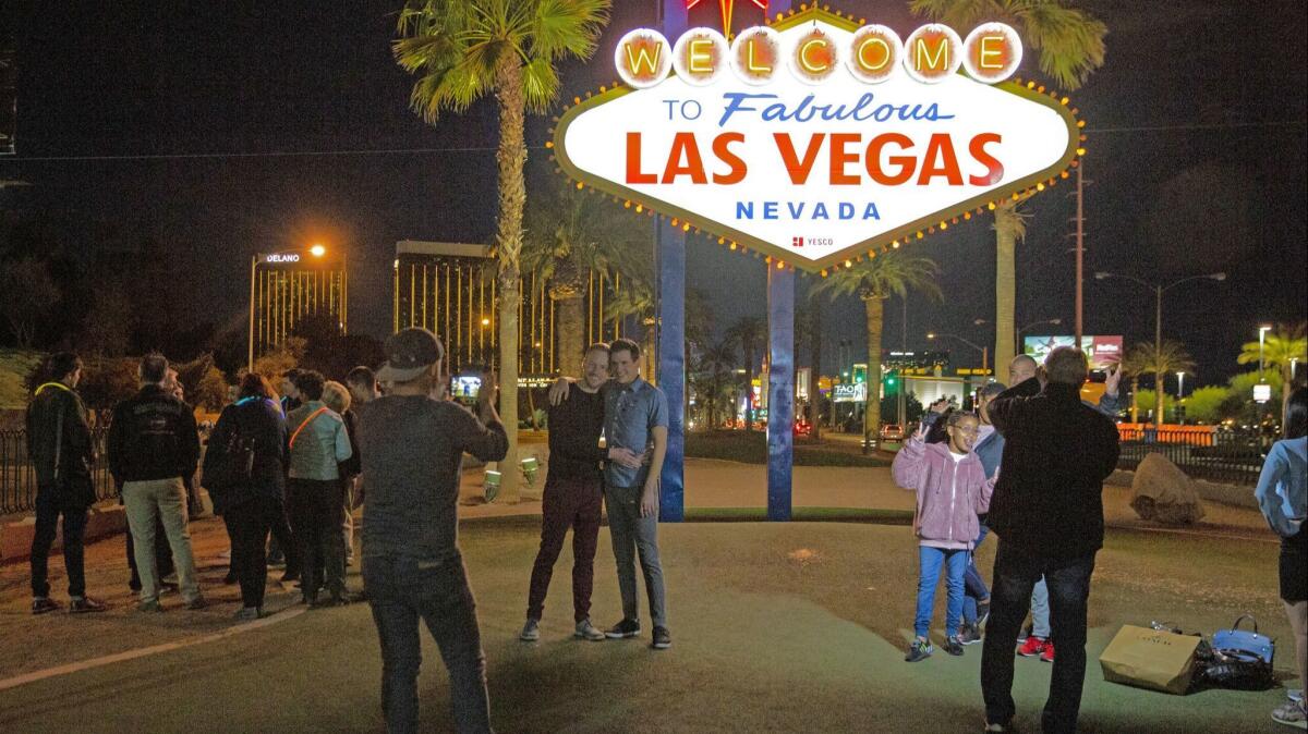 People pose for pictures at the iconic Las Vegas sign at all hours of the day or night.