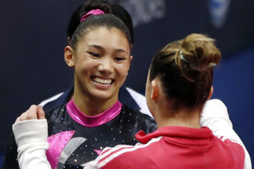 Kyla Ross, left, receives a hug from McKayla Maroney after the first round of the U.S. women's national gymnastics championships in Hartford, Conn., in August.