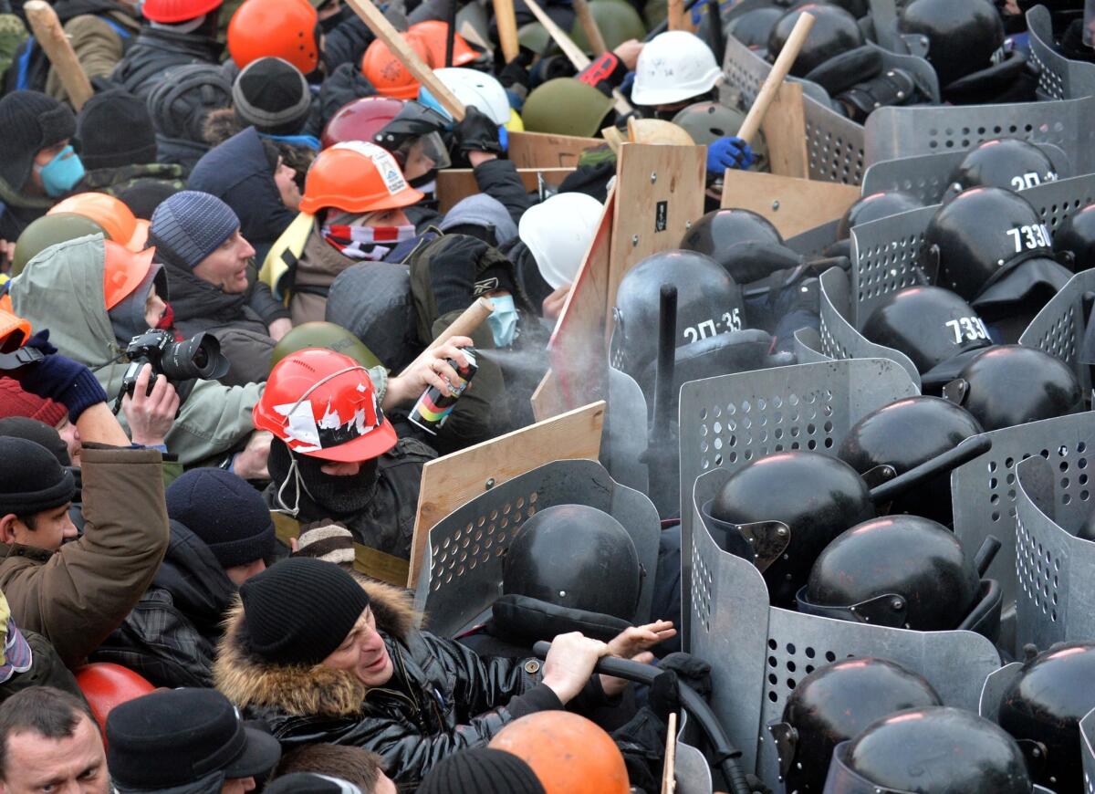 Protesters clash with police during an opposition rally in the center of the Ukrainian capital of Kiev.