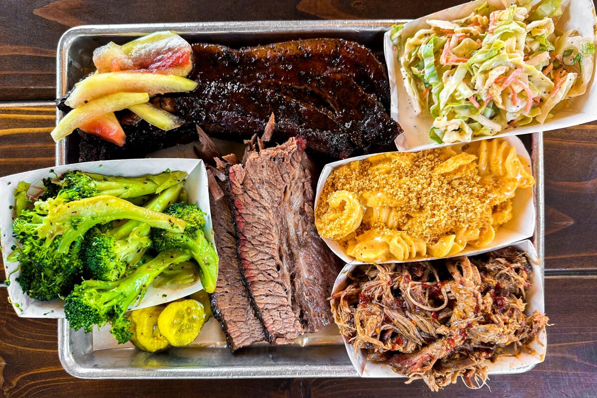 Barbecue platter at Soulbelly featuring brisket, broccoli, coleslaw, mac and cheese and more