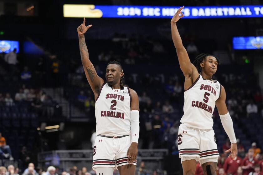 South Carolina's B.J. Mack (2) reacts with Meechie Johnson (5) after hitting a three-point basket during the second half of an NCAA college basketball game against Arkansas at the Southeastern Conference tournament Thursday, March 14, 2024, in Nashville, Tenn. (AP Photo/John Bazemore)