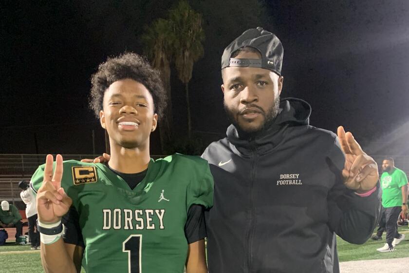 Deuce Johnson (left) and his father, Dorsey coach Stafon Johnson.