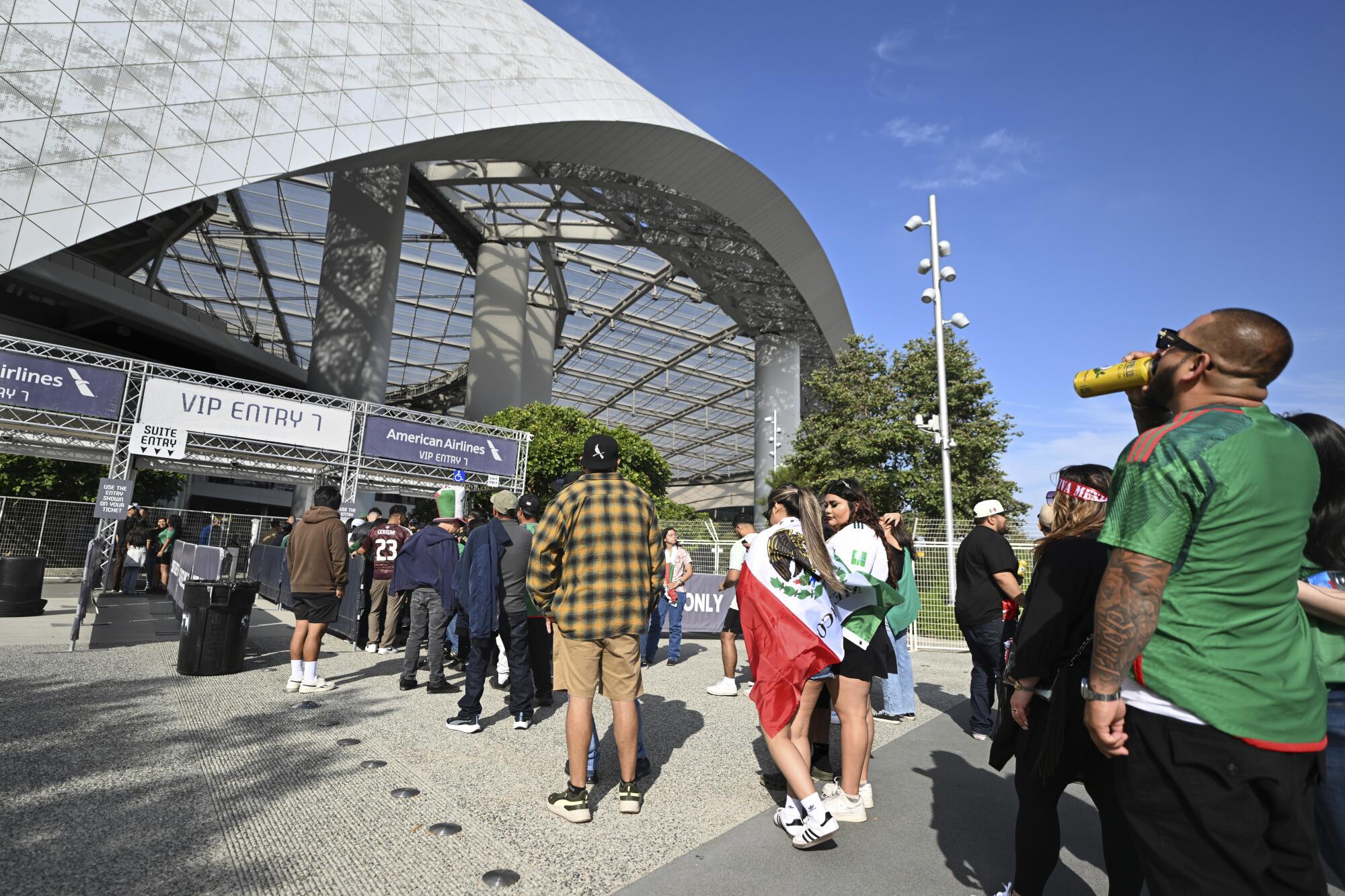 Fans wait in line to enter sofi stadium beforme a co