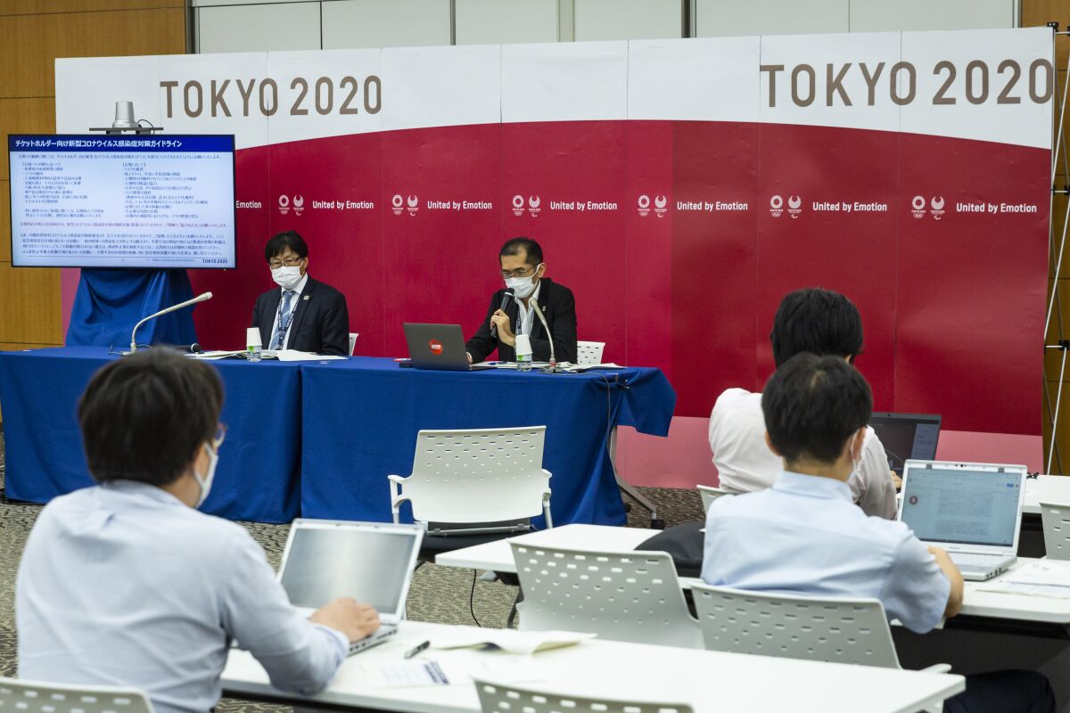Deputy Executive Director, Marketing & Senior Director of Ticketing of Tokyo 2020 Organizing Committee Suzuki Hidenori, left, and Spokesperson of Tokyo 2020 Organizing Committee Masa Takaya attend a press conference regarding Olympic and Paralympic Games tickets, Friday, July 9, 2021, in Tokyo. Tokyo Olympic organizers stated yesterday that spectators would be barred from most events at the Games after a new state of emergency was announced in response to a surge in coronavirus cases. The state of emergency will run throughout the Olympic Games and remain in place until August 22. (Yuichi Yamazaki/Pool Photo via AP)