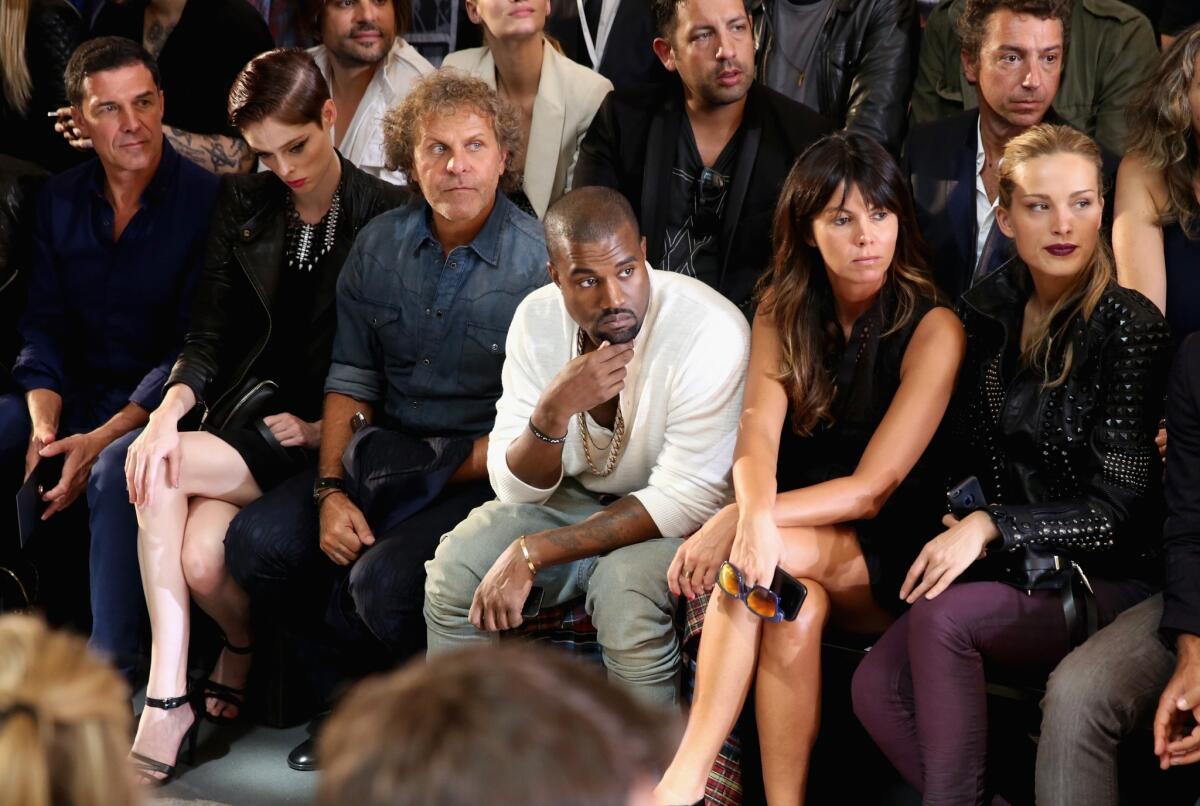 Kanye West, center, sits front row at the Diesel Black Gold show during New York Fashion Week.