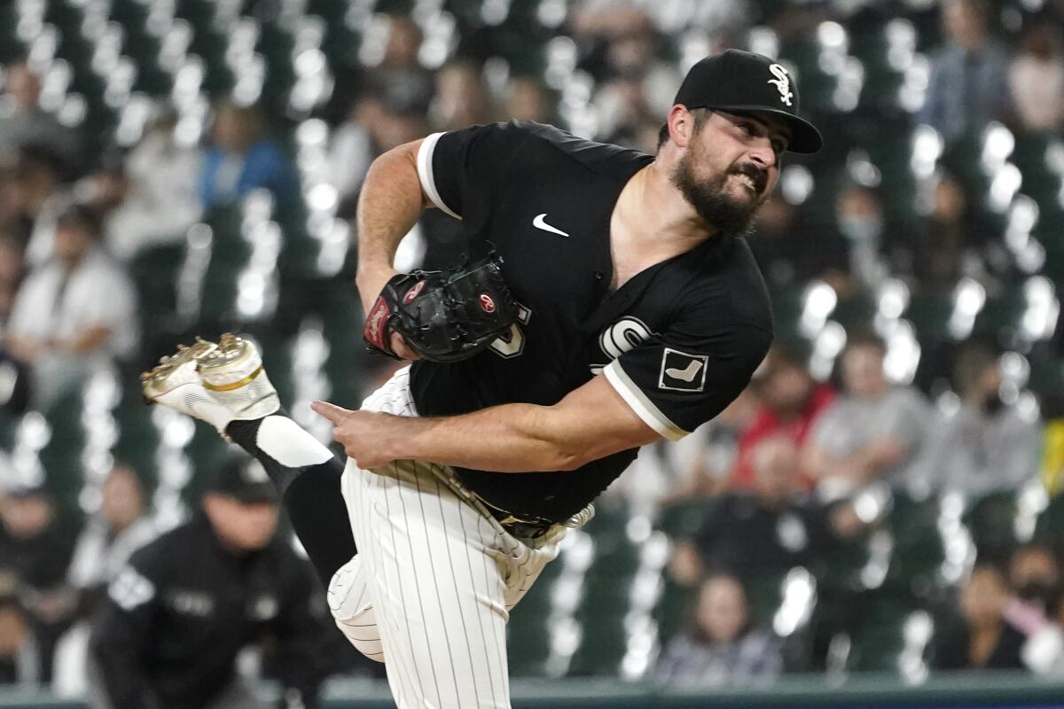 Chicago White Sox starting pitcher Carlos Rodon follows through during the first inning of a baseball game against the Cincinnati Reds Wednesday, Sept. 29, 2021, in Chicago. (AP Photo/Charles Rex Arbogast)