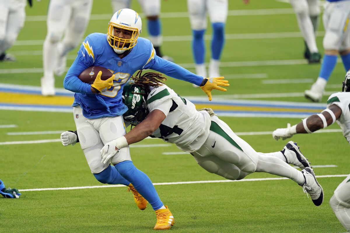 The Chargers' Keenan Allen, left, is tackled by New York Jets linebacker Harvey Langi after a second-half reception. 