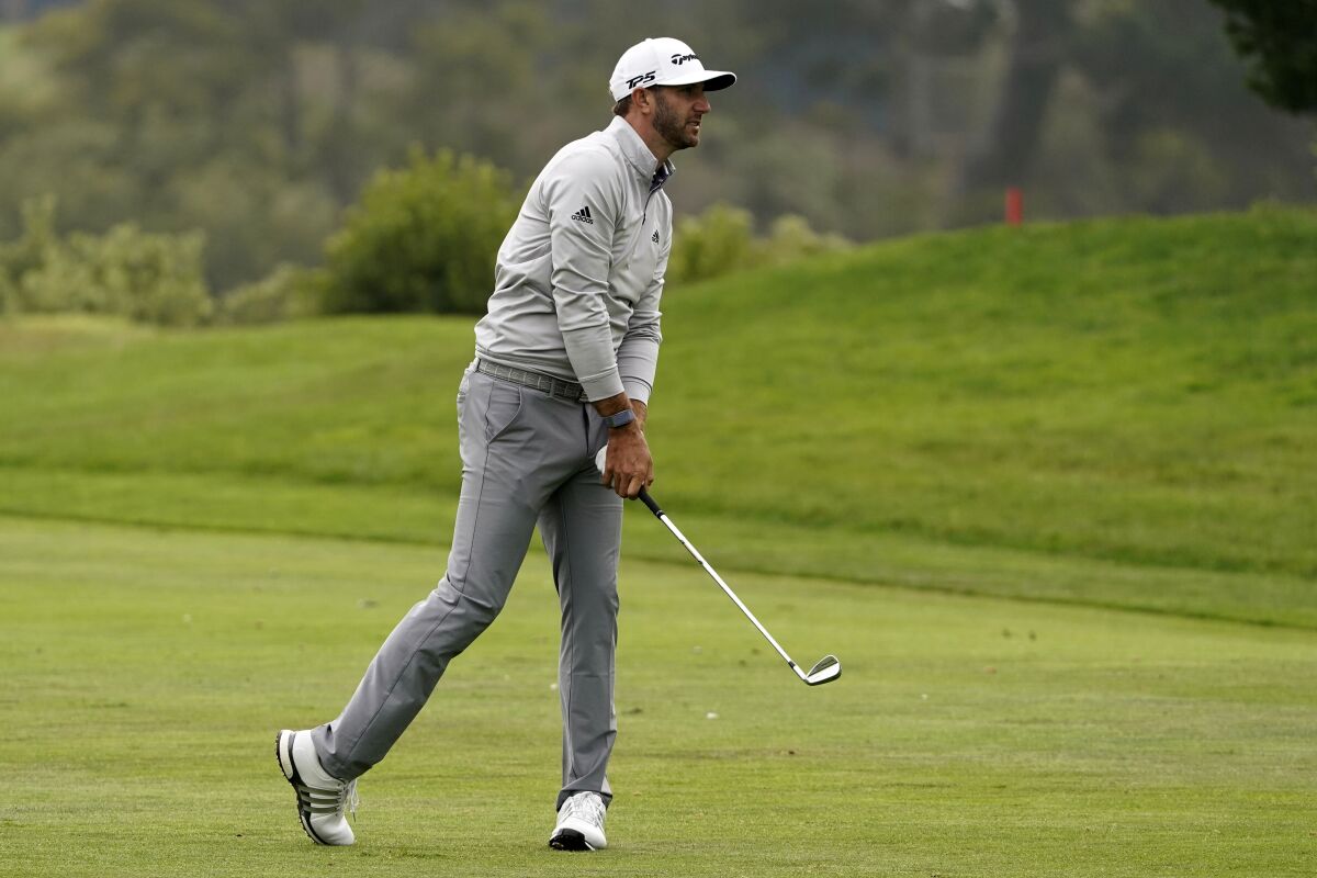 Dustin Johnson hits from the fairway on the 18th hole during the third round of the PGA Championship golf tournament at TPC Harding Park Saturday, Aug. 8, 2020, in San Francisco. (AP Photo/Charlie Riedel)