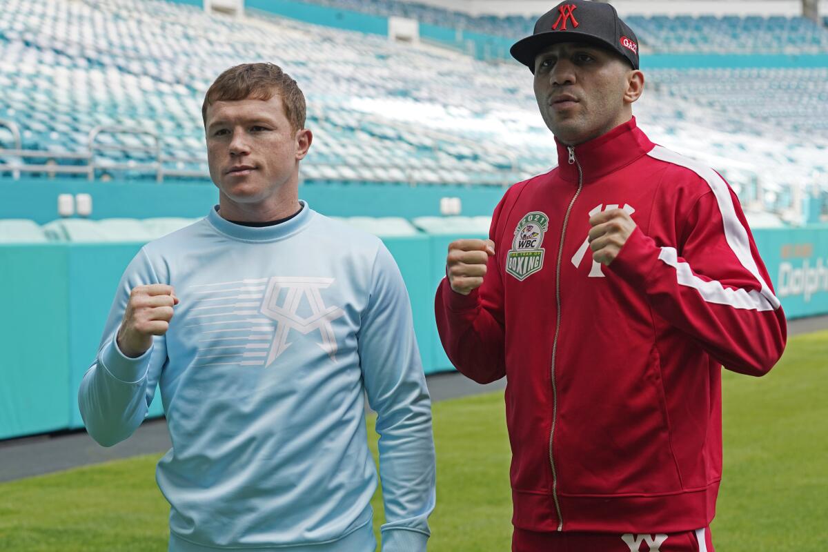 Boxers Canelo Alvarez, left, and Avni Yildirim pose for photos at Hard Rock Stadium on Monday.