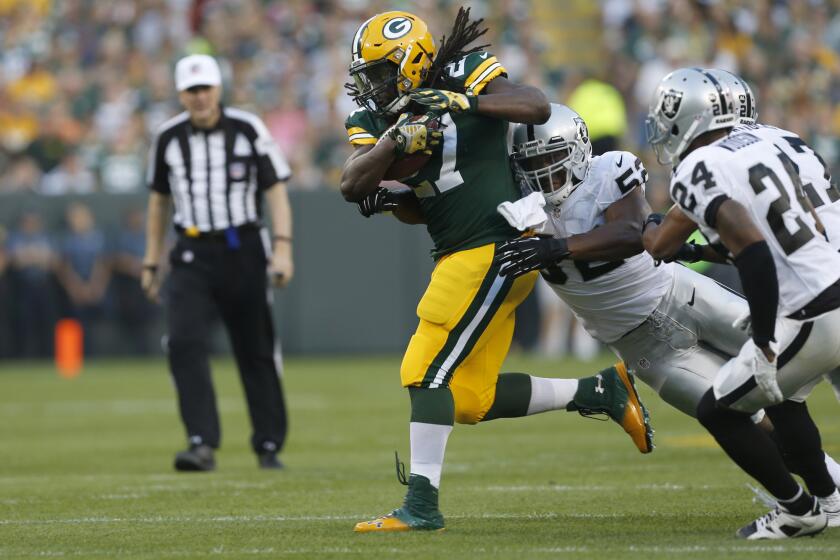Green Bay Packers running back Eddie Lacy carries the ball against the Oakland Raiders during a preseason game.