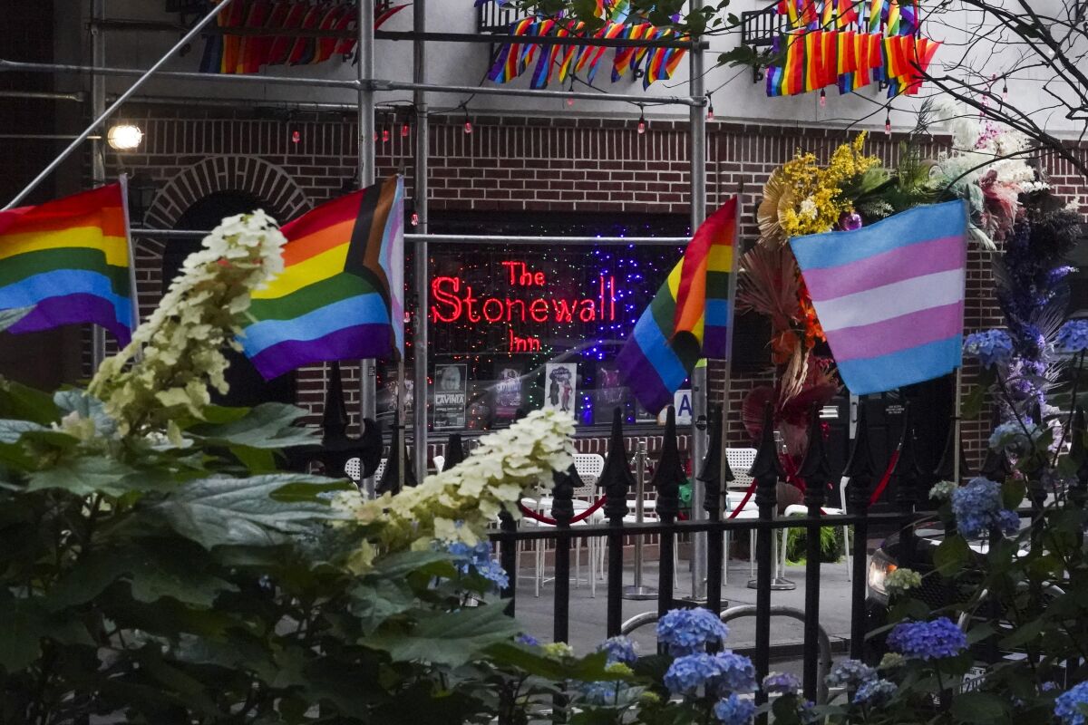 Flags affirming LGBTQ identity dress the fencing surrounding the Stonewall National Monument in New York. 
