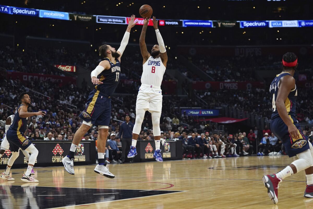 New Orleans Pelicans guard Dyson Daniels tries to block a shot by Los Angeles Clippers forward Marcus Morris Sr. (8) during the second half of an NBA basketball game on Sunday, Oct. 30, 2022, in Los Angeles. (AP Photo/Allison Dinner)