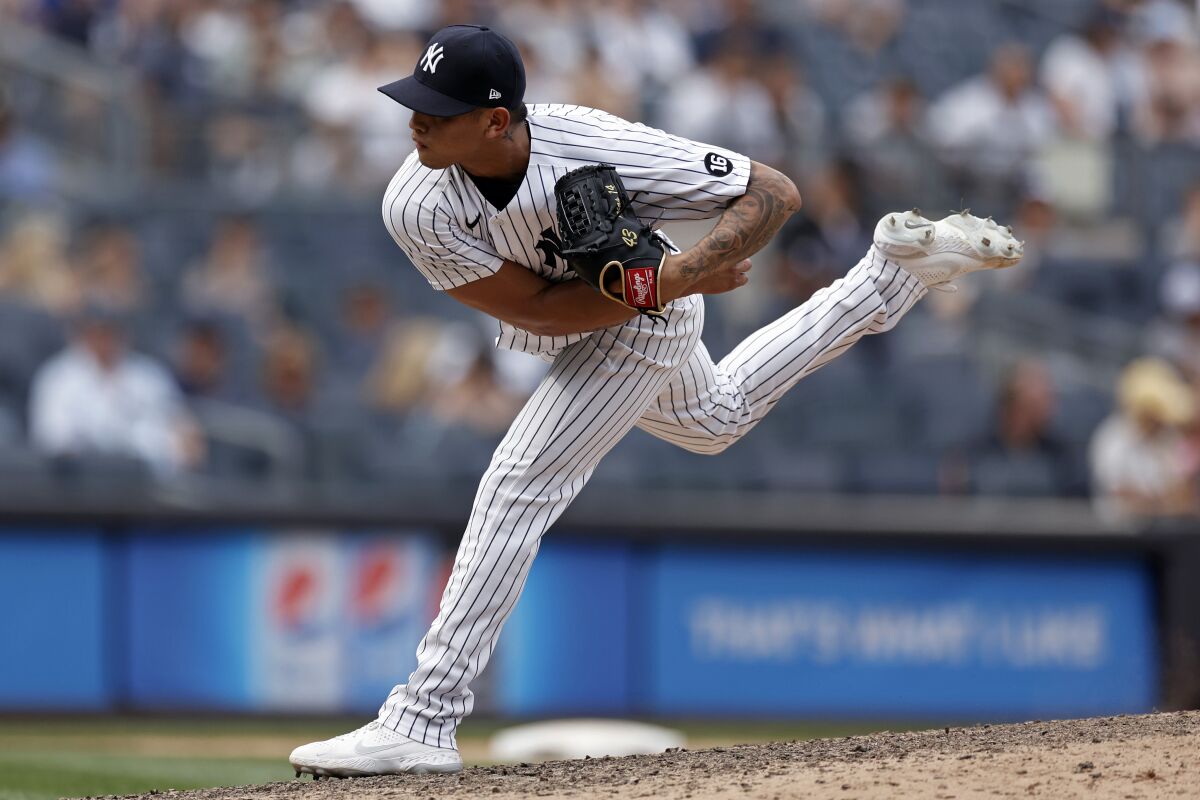 New York Yankees pitcher Jonathan Loaisiga delivers a pitch during the ninth inning of a baseball game against the Seattle Mariners on Saturday, Aug. 7, 2021, in New York. The Yankees won 5-4. (AP Photo/Adam Hunger)