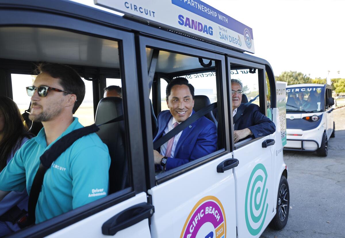 San Diego Mayor Todd Gloria and Councilmember Joe LaCava take a ride in a Beach Bug on Wednesday with the shuttle's launch.