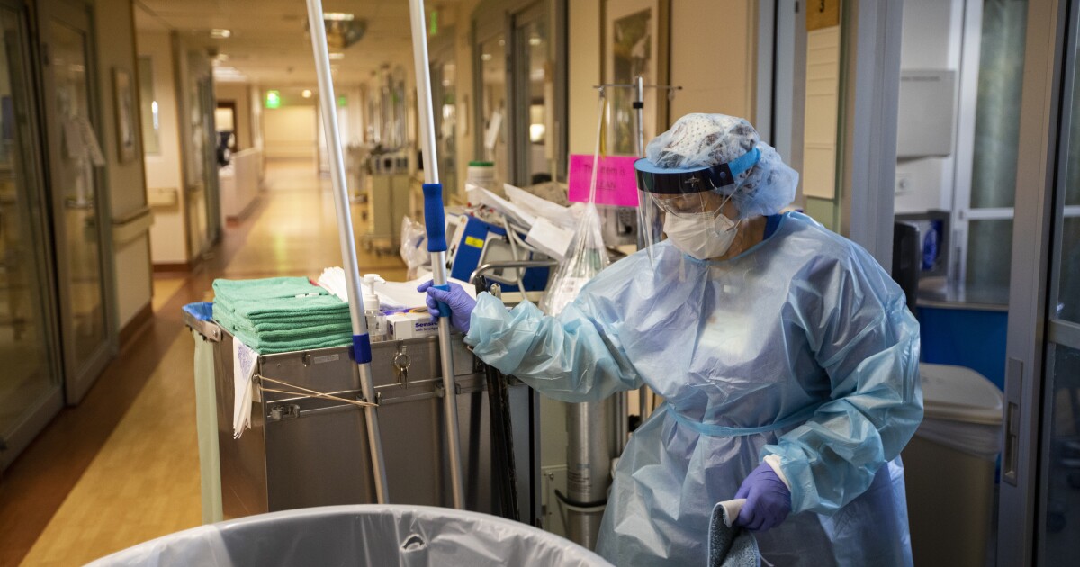 Maria Padilla, with Environmental Services, rolling their trolley in the hallway at Providence St. Jude Medical Center on Christmas Day.