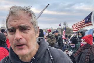 This image from video recorded Jan. 6, 2021, captures Vincent Gillespie on the grounds of the U.S. Capitol in Washington where prosecutors say he was among a rioting mob trying to gain control of the building from the federal government. (AP Photo/Ben Fox)