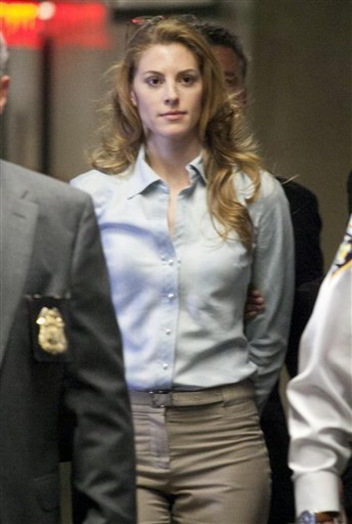 Jaynie Mae Baker arrives with court officers and legal counsel for her arraignment in State Supreme Court, Tuesday, March 13, 2012 in New York. Baker is accused of working for a high-priced brothel. (AP Photo/Mark Lennihan)