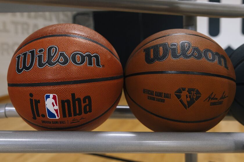 A Jr. NBA ball and NBA game ball are displayed on the test court in the Wilson Innovation Center 