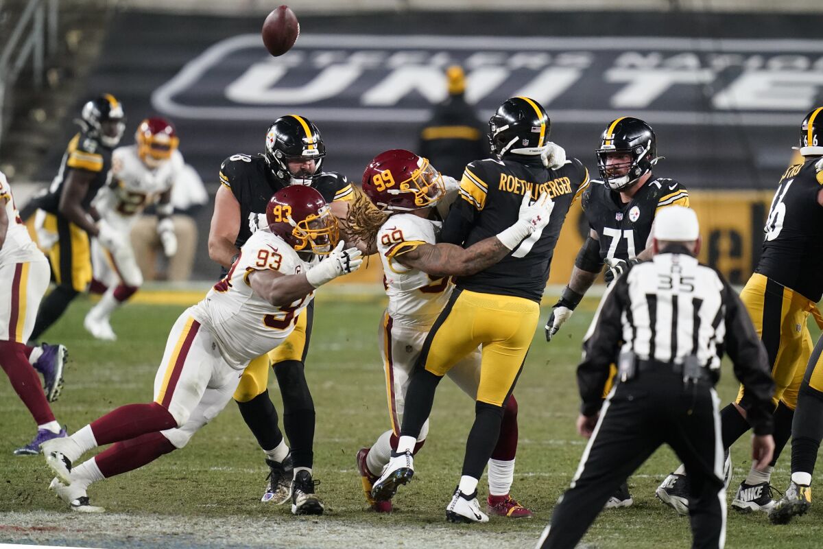 Pittsburgh Steelers quarterback Ben Roethlisberger is hit by Washington Football Team defensive end Chase Young.