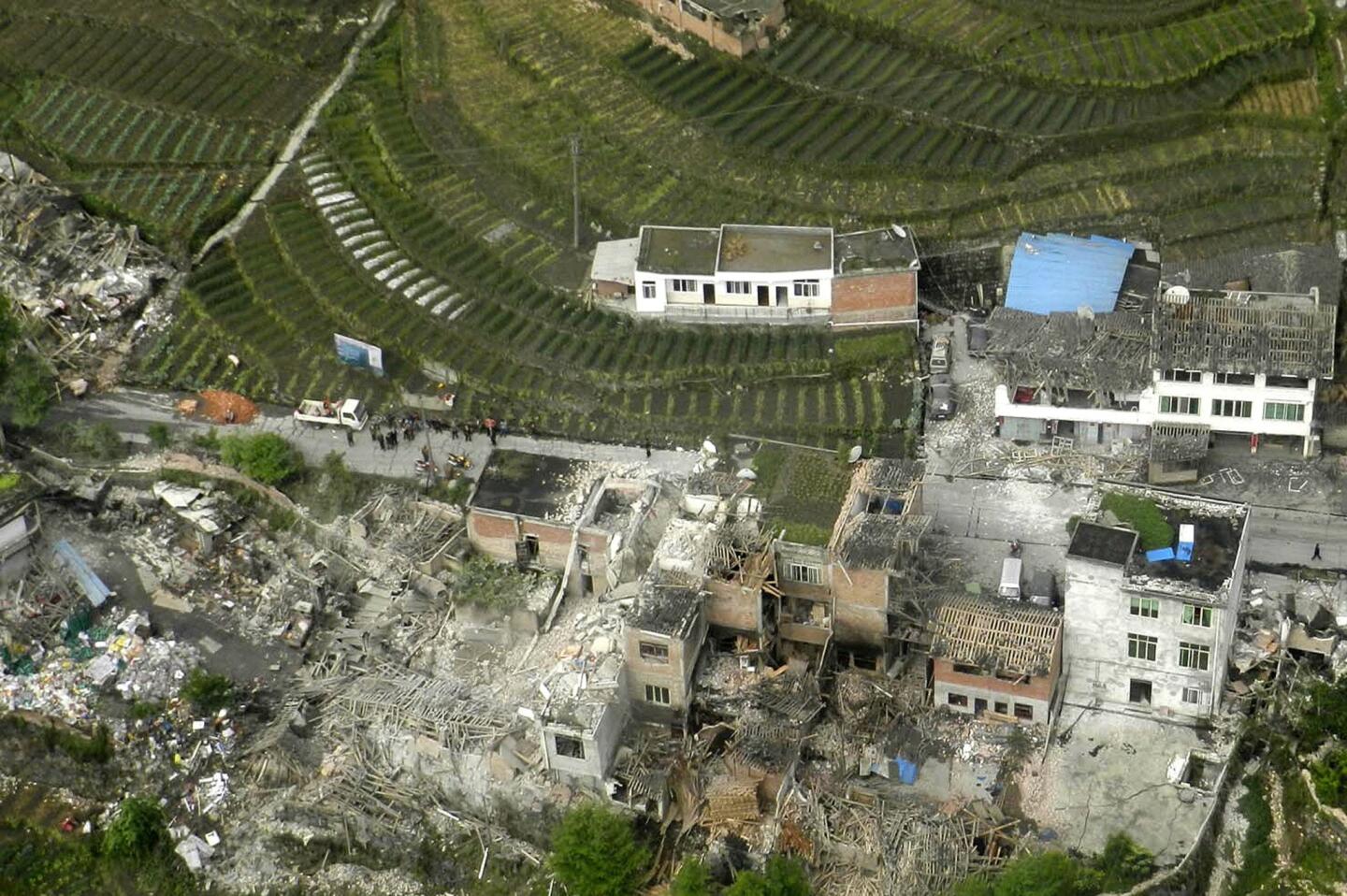 This aerial photo released by China's Xinhua news agency shows destroyed houses after a powerful earthquake hit Lushan County's Ya'an City in China's Sichuan Province. The powerful earthquake jolted the province near where a devastating quake struck five years ago.