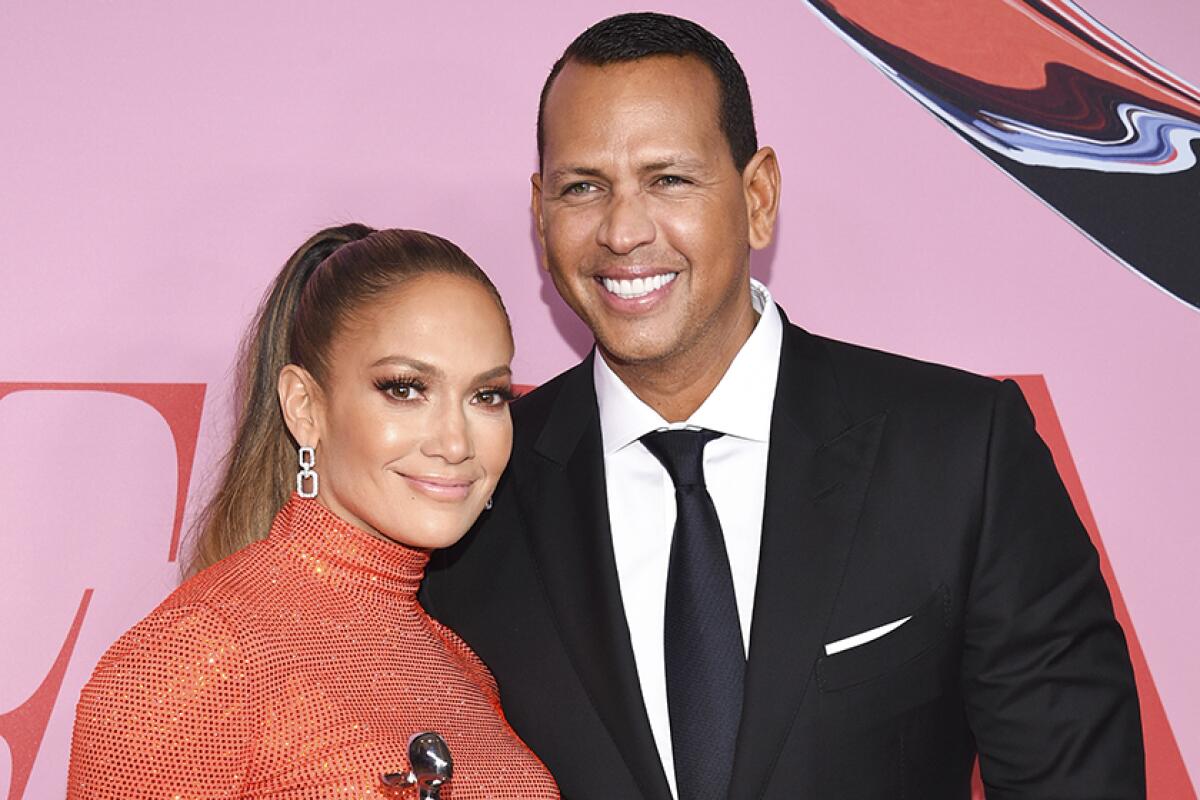 Jennifer Lopez and Alex Rodriguez pose for a photo.