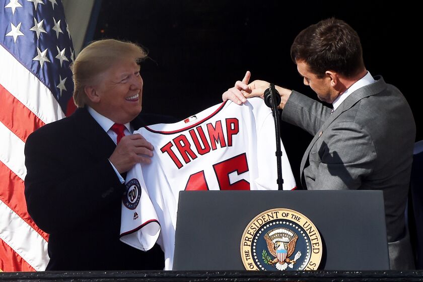 US President Donald Trump received a jersey from Nationals player Ryan Zimmerman (R) during a ceremony to welcome the 2019 World Series Champions, the Washington Nationals on the South Lawn of the White House in Washington, DC, November 04, 2019. (Photo by Olivier Douliery / AFP) (Photo by OLIVIER DOULIERY/AFP via Getty Images)