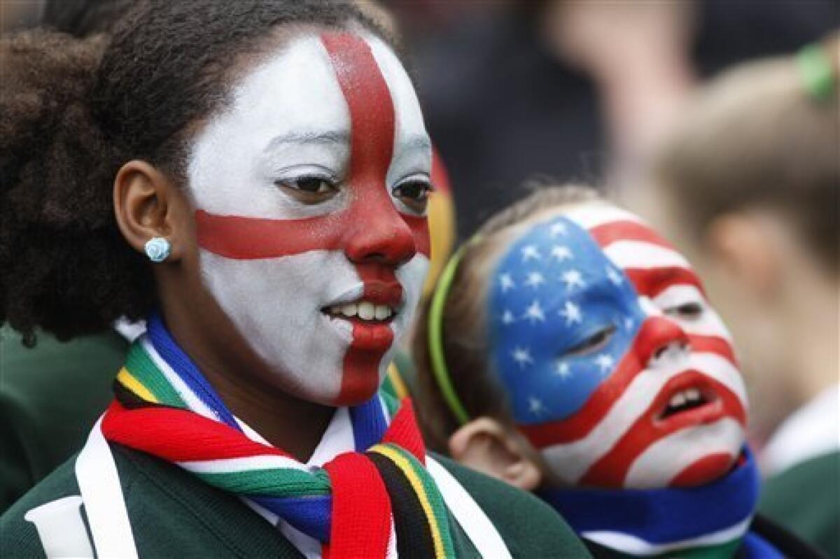 Pupils from St Joseph's Primary School with their faces painted in the participating country flags of England, left, and the U.S., wait for a special event to mark the start of South Africa World Cup Soccer at Trafalgar Square in London and to show support for England's bid to host the 2018 FIFA World Cup, Friday, June 11, 2010. (AP Photo/Sang Tan)