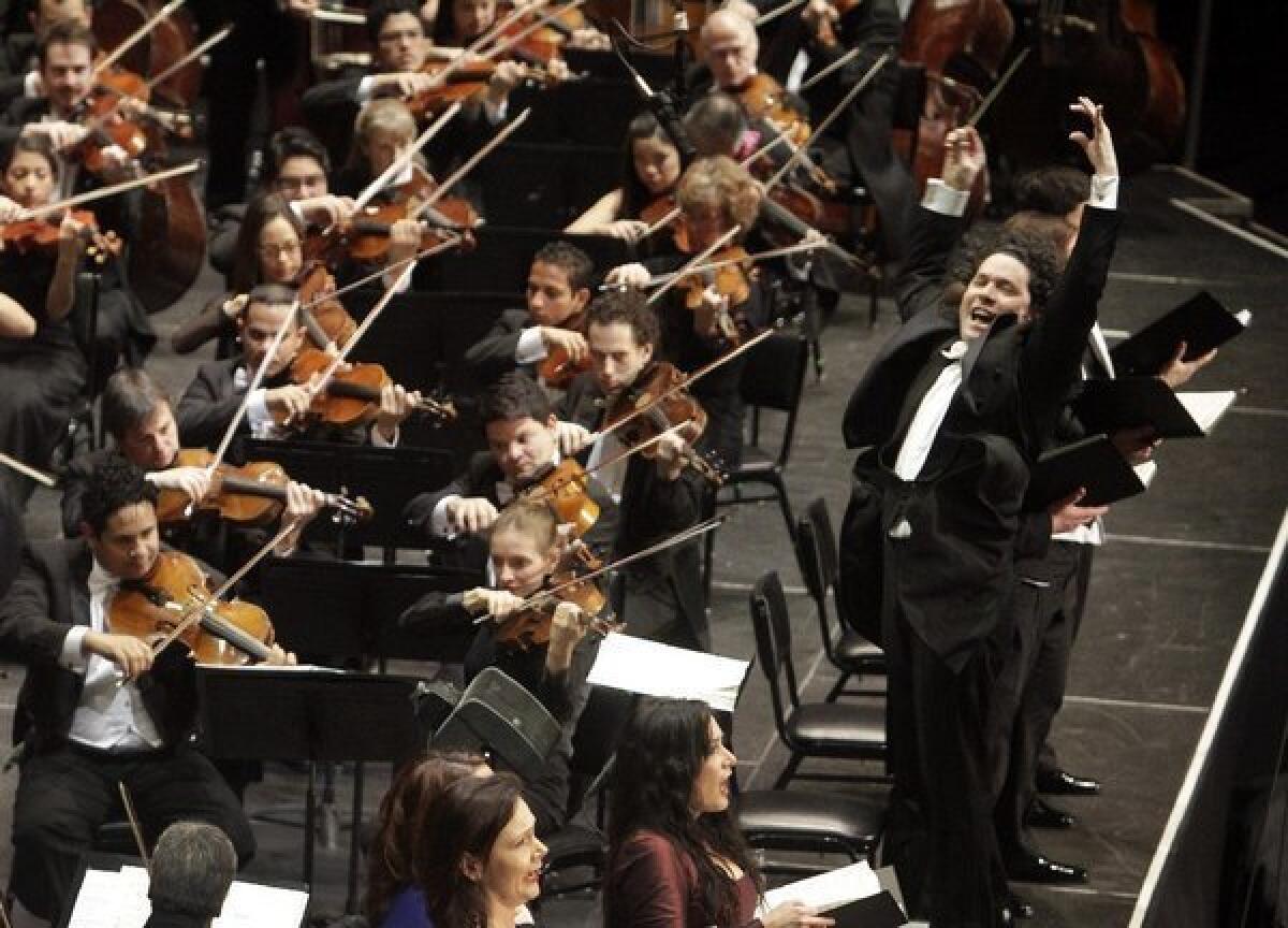 Gustavo Dudamel conducting members of the Los Angeles Philharmonic and the Simon Bolivar Symphony Orchestra in Mahler's Eighth Symphony at the Shrine Auditorium in 2012.