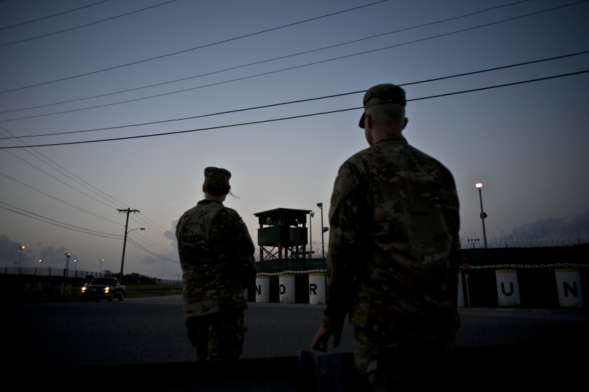 FILE - In this June 5, 2018 photo, reviewed by U.S. military officials, troops stand guard outside Camp Delta at the Guantanamo Bay detention center, in Cuba. The 20th anniversary of the first prisoners' arrival at the Guantanamo Bay detention center is on Tuesday, Jan. 11, 2022. There are now 39 prisoners left. At its peak, in 2003, the detention center held nearly 680 prisoners. (AP Photo/Ramon Espinosa, File)