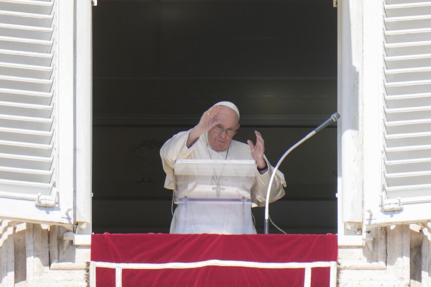 Pope Francis waves during the Angelus noon prayer from the window of his studio overlooking St.Peter's Square, at the Vatican, Sunday, Oct. 2, 2022. Pope Francis has appealed to Russian President Vladimir Putin, imploring him to "stop this spiral of violence and death" in Ukraine. The pontiff also called on Ukrainian President Volodymyr Zelenskyy to "be open" to serious peace proposals. (AP Photo/Alessandra Tarantino)