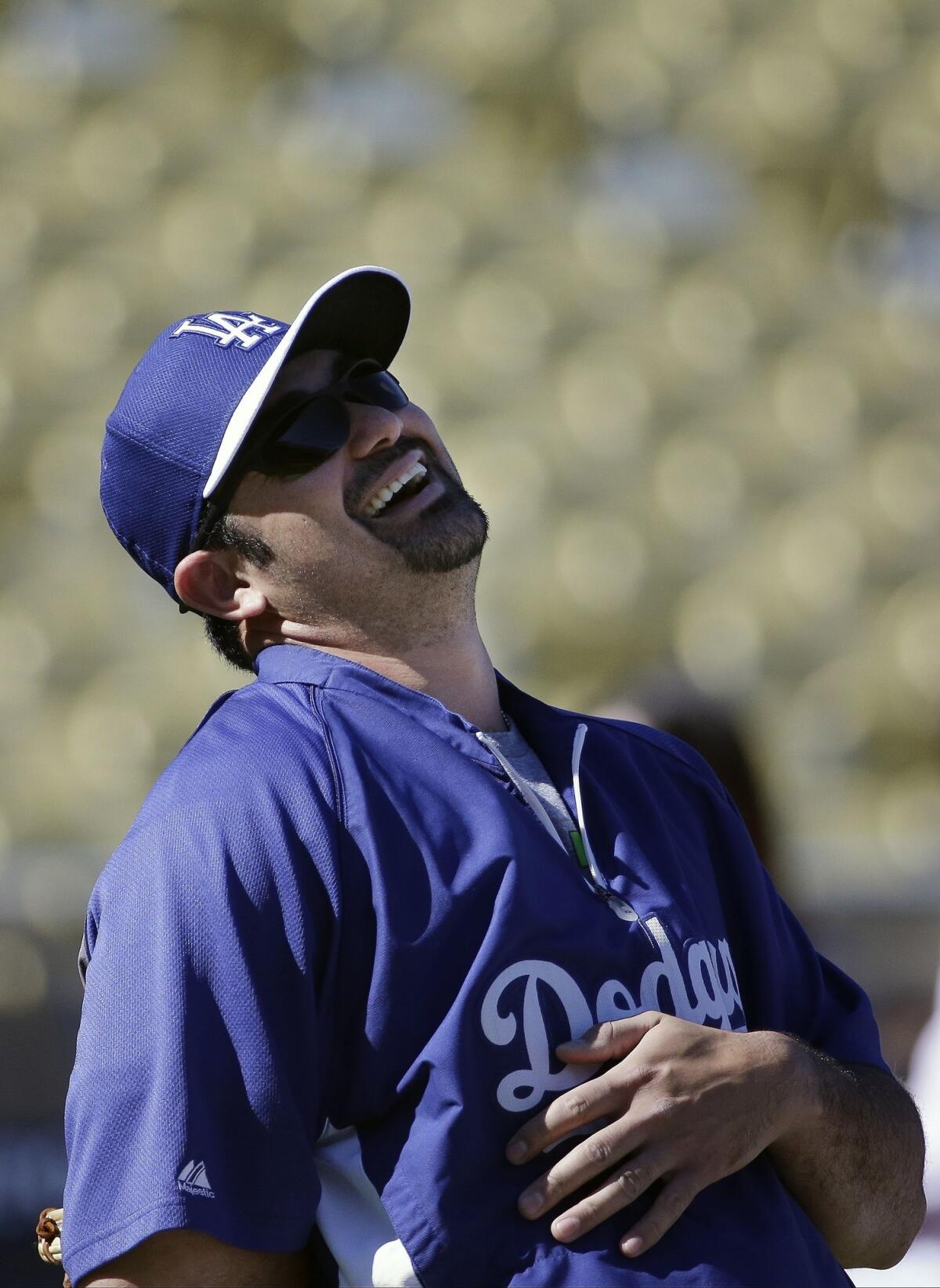 Dodgers first baseman Adrian Gonzalez isn't taunting the Cardinals, he's laughing during batting practice for Game 4 of the National League Championship Series on Tuesday.