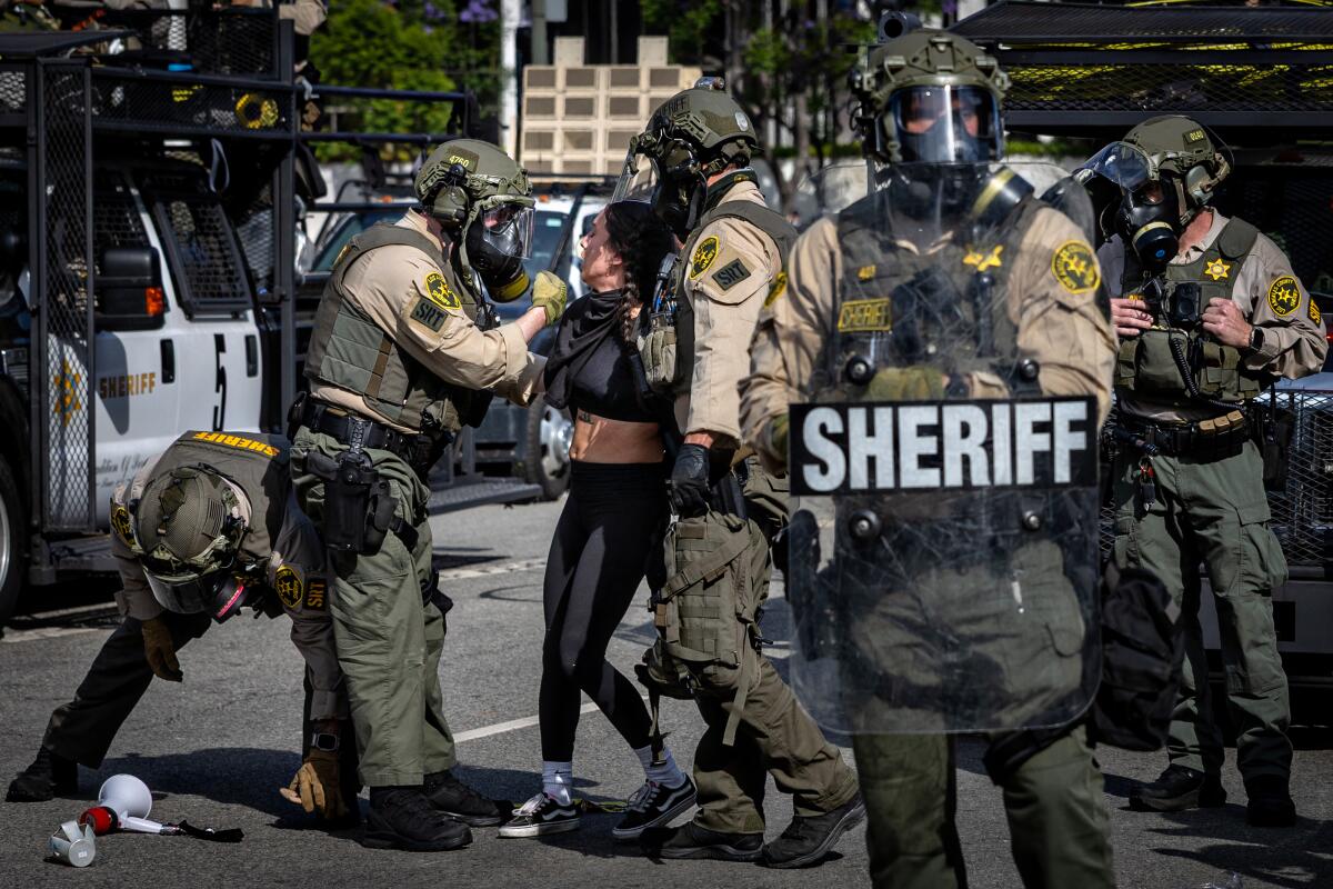Protesters clash against law enforcement at the "No Kings" Day