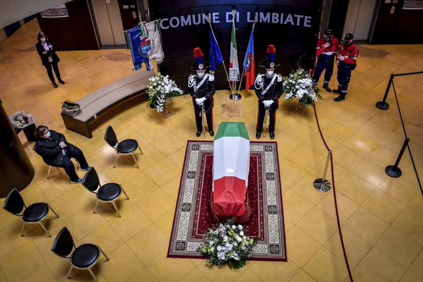 FILE - Carabinieri officers stand by the coffin of Italian ambassador to the Democratic Republic of Congo Luca Attanasio, in Limbiate, near Milan, Italy, Feb. 26, 2021. Italy says it is seeking “maximum cooperation” from the World Food Program after Rome prosecutors indicated they would seek indictments against two U.N. employees in connection with the 2021 killing of Attanasio and two others. The Foreign Ministry issued the appeal for cooperation after prosecutors closed the investigation on Wednesday, Feb. 9, 2022 saying they had gathered enough evidence to support a manslaughter indictment against the two.(Claudio Furlan/LaPresse via AP, file)