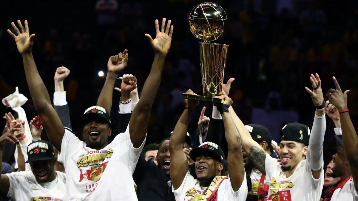 The Toronto Raptors celebrate with the Larry O'Brien Championship Trophy after their team defeated the Golden State Warriors to win Game 6 of the NBA Finals on Thursday in Oakland.