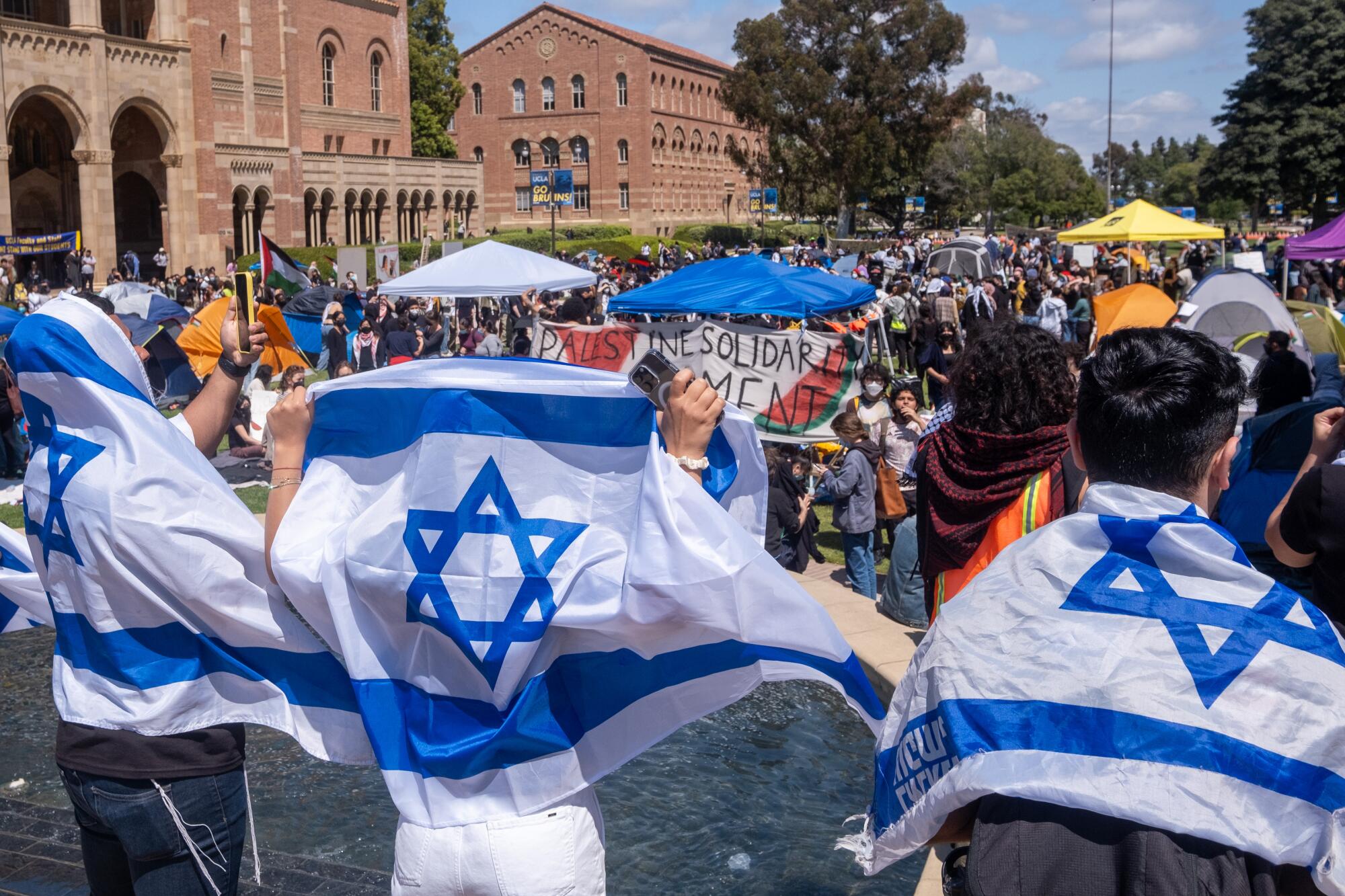 Pro-Israeli demonstrators gather near an encampment set up by pro-Palestine protesters on the campus of UCLA on April 25.
