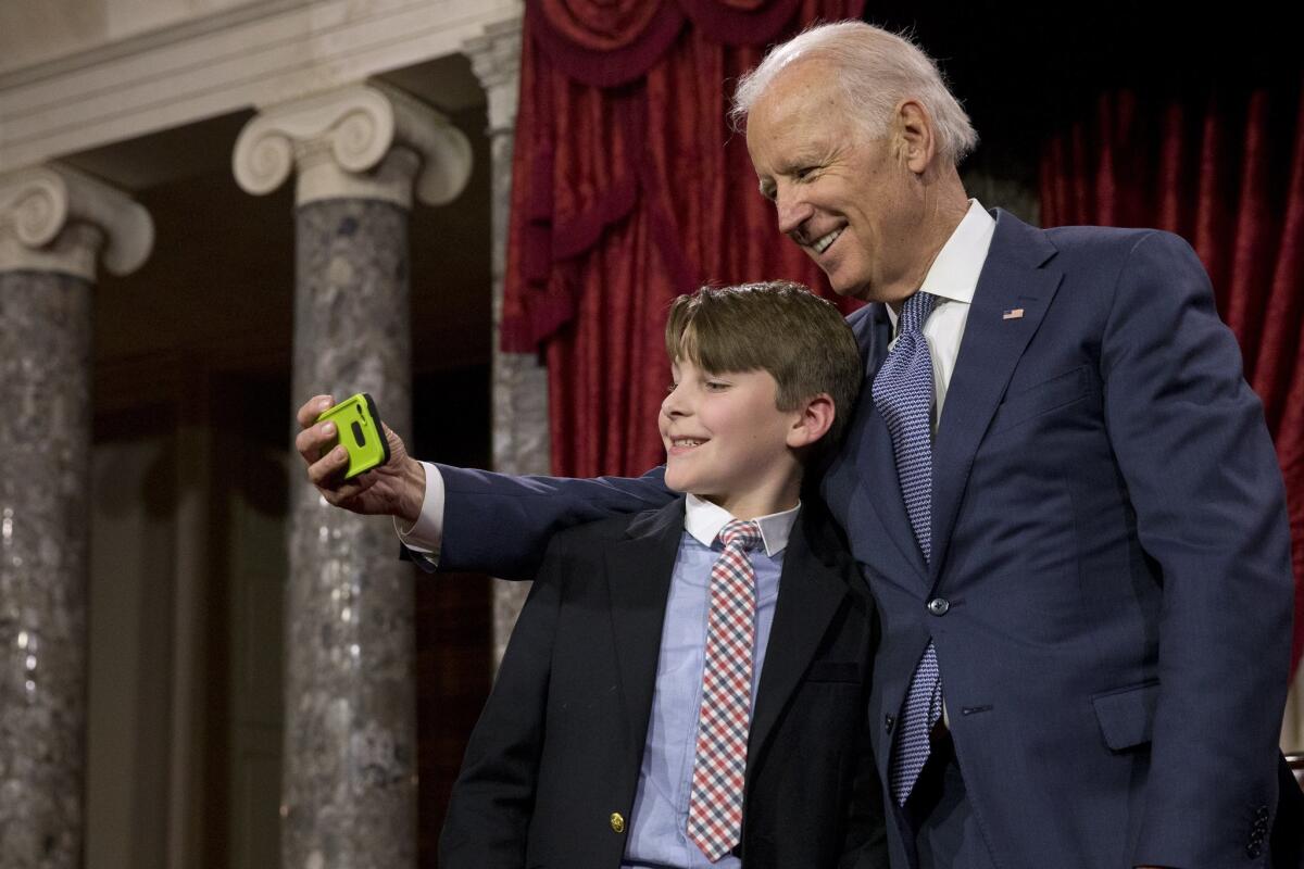 Vice President Joe Biden takes a "selfie" with Sen. Jeanne Shaheen's grandson A.J. Bellabona in the Old Senate Chamber at the U.S. Capitol in Washington.
