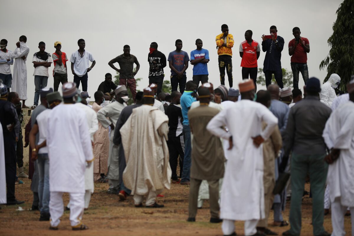Mourners gather at a burial ground in Abuja, Nigeria, where presidential chief of staff Abba Kyari was buried April 18 after contracting the coronavirus.